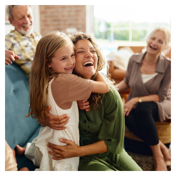 Mom hugging daughter and laughing